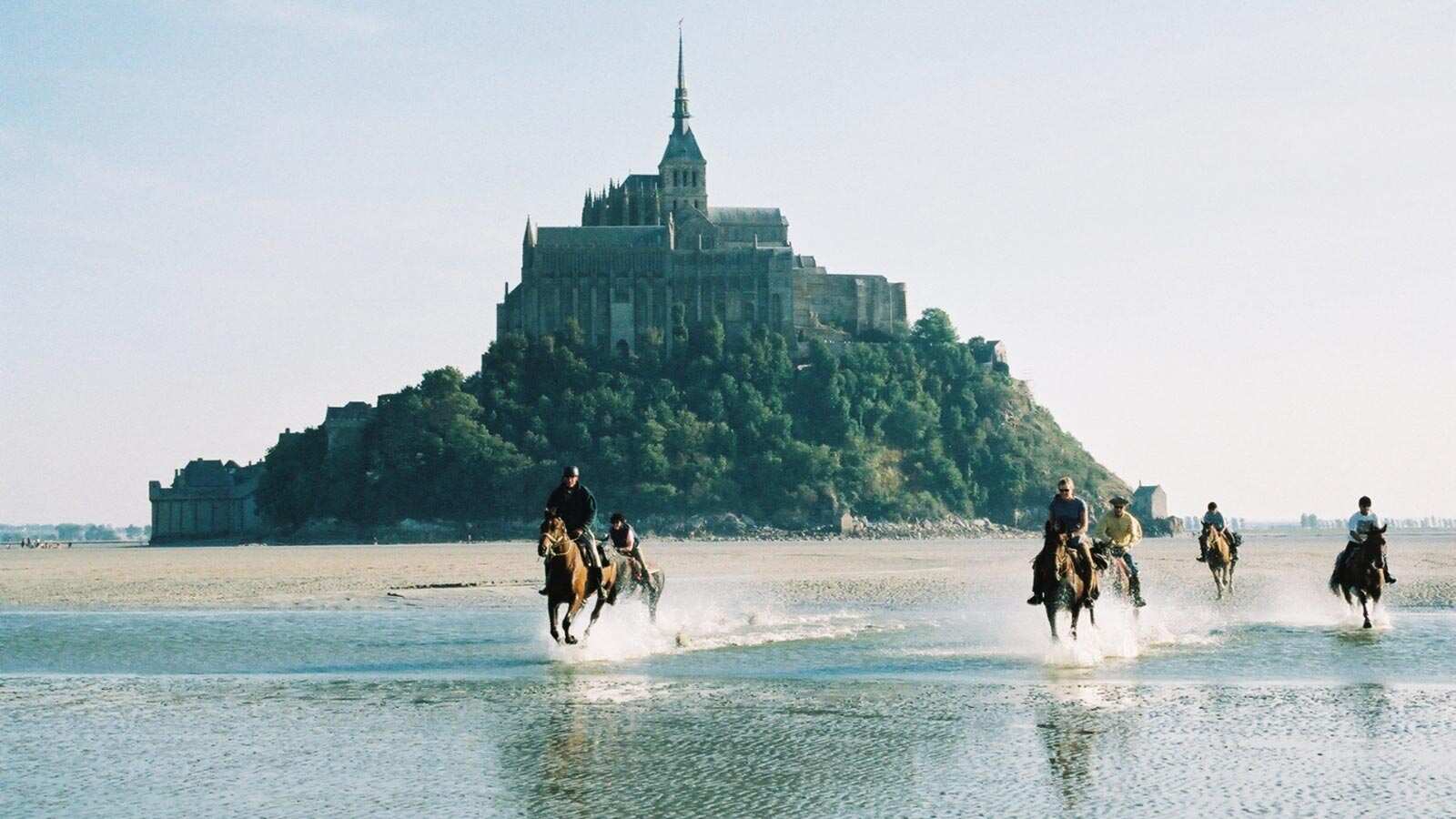 Horse racing event across water in Normandy, France