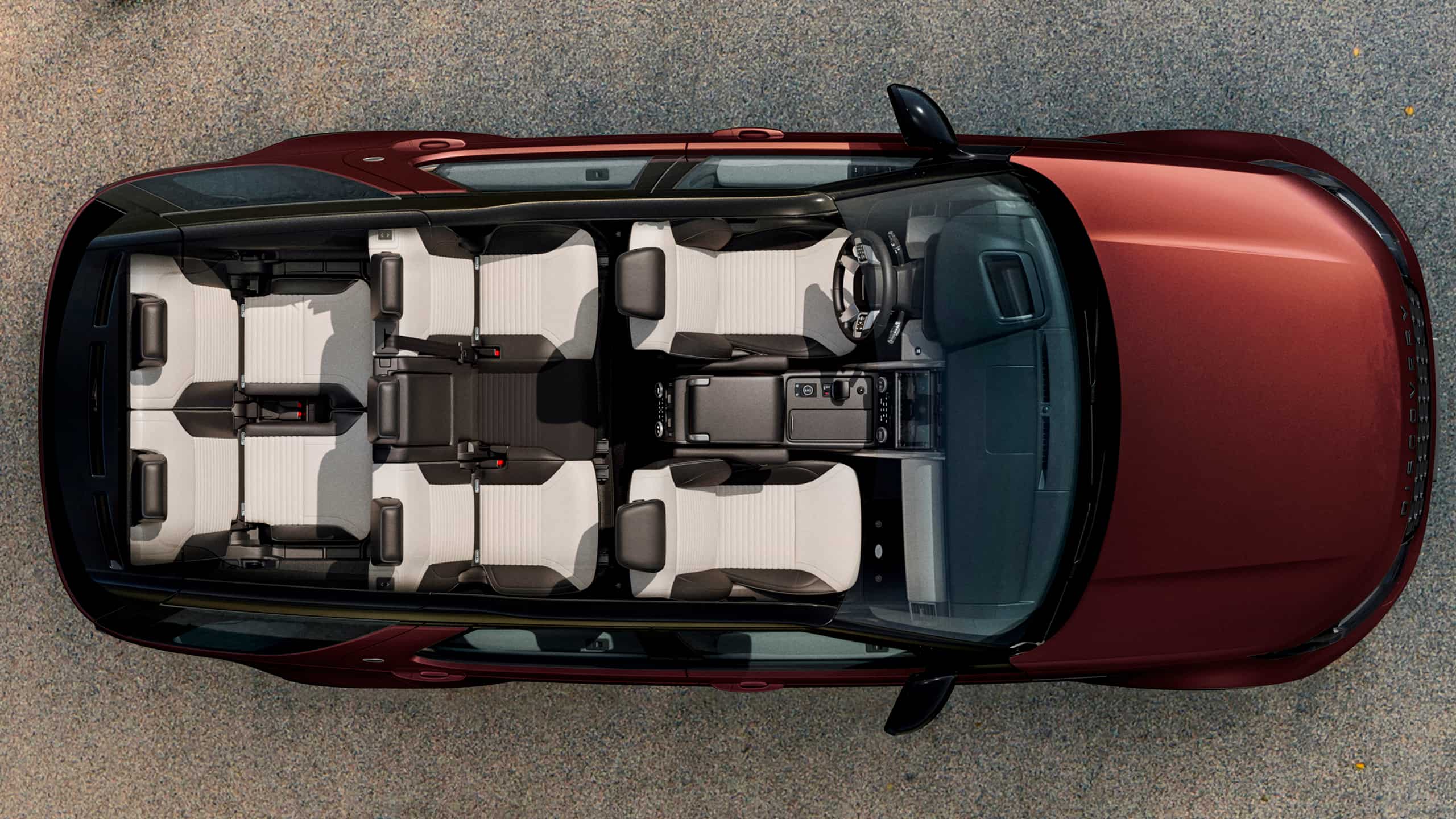 Top-Down View Of The Three Rows Of Seats In A Red Land Rover Discovery