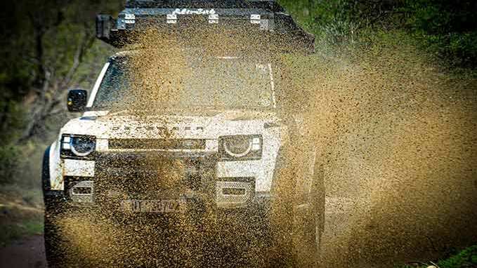 Dust blown by driven Defender on the road