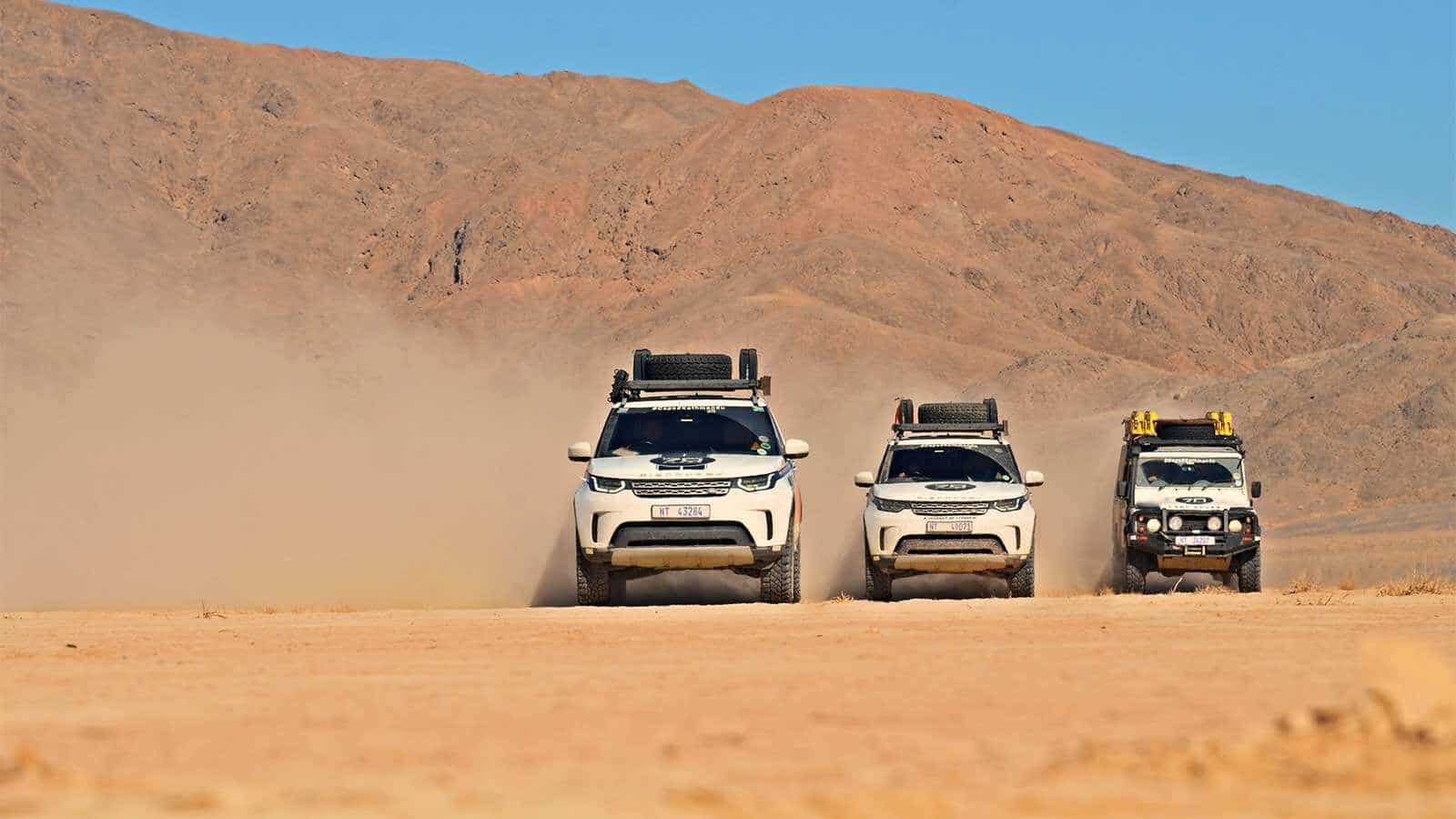 Range Rovers driving in the desert